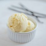 Vanilla Bean Ice cream with vanilla beans in the backdrop
